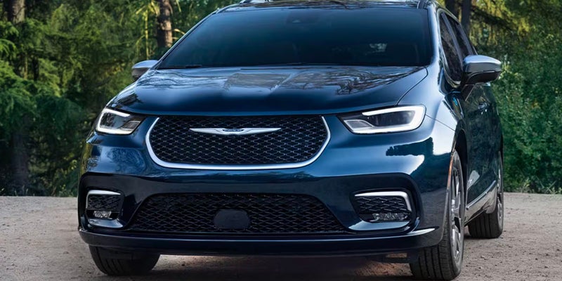 Front view of a dark blue minivan parked outdoors