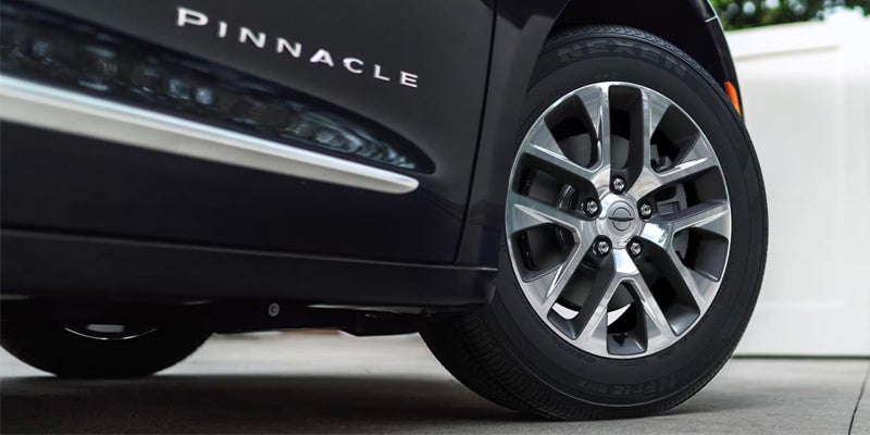Detailed view of the 'Pinnacle' badge and a polished wheel