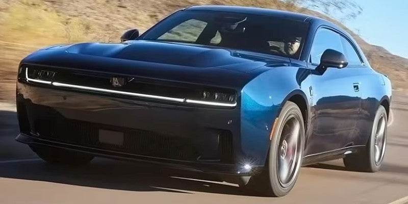 Blue Dodge Charger muscle car driving fast