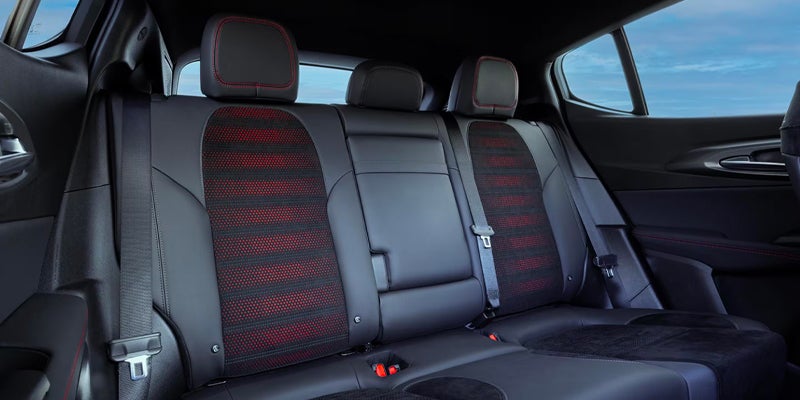 Rear seats of an Alfa Romeo with red stitching and striped inserts