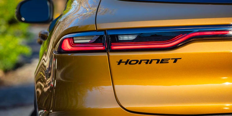 Close-up of the rear taillights and HORNET badge on a gold SUV