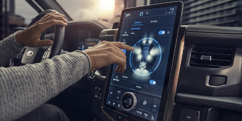 hand using the f-150 lightning's touchscreen