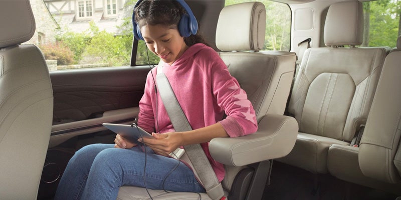 child watching a tablet inside the ford expedition