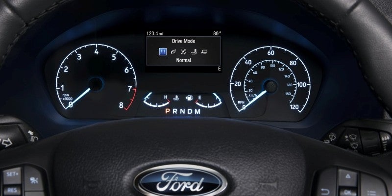 The dashboard and instrument cluster of a Ford transit van.