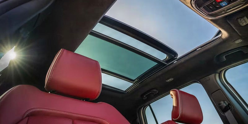 Interior view of the Jeep Wagoneer S panoramic sunroof over red seats