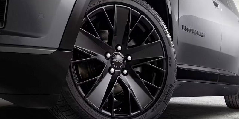 Close-up of the black wheel and tire on the Jeep Wagoneer S
