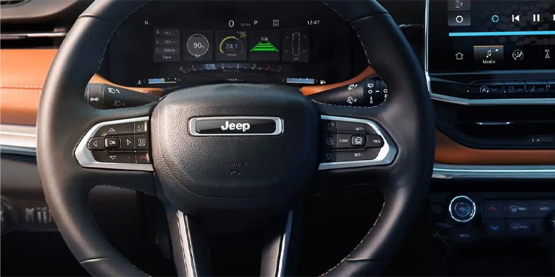 Close-up of the Jeep Compass steering wheel and digital instrument cluster