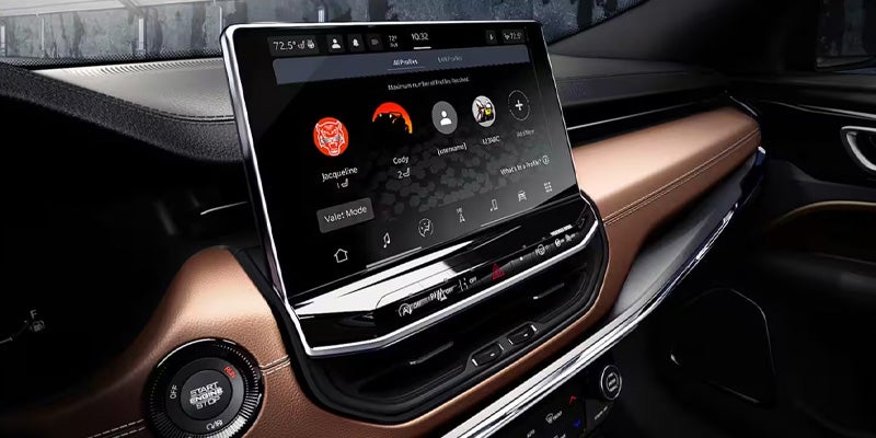 Close-up of the large touchscreen display and brown leather trim in the interior