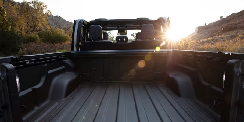 View of the empty truck bed of a Jeep Gladiator at sunset