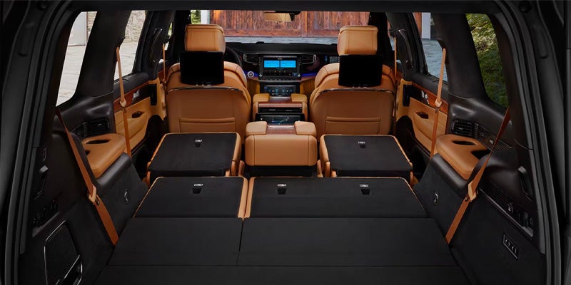 The interior of a Grand Wagoneer with the back seats folded down to show the large cargo area