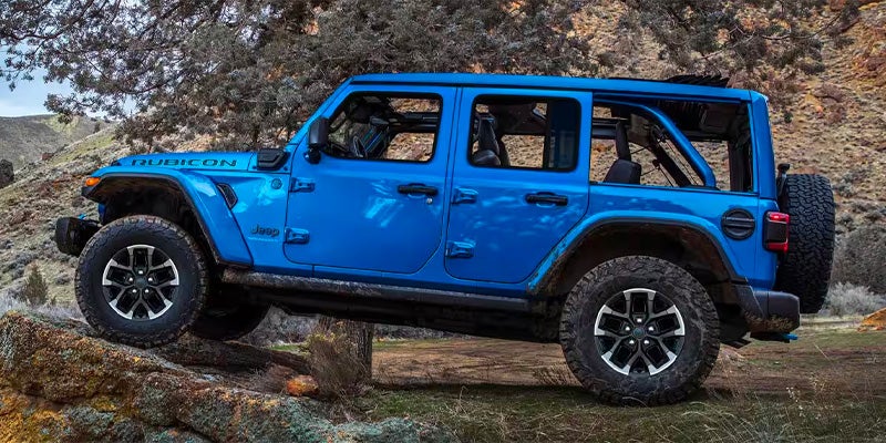 Blue Jeep Wrangler 4xe plug-in hybrid driving