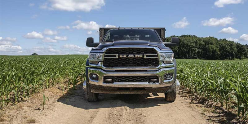 Front view of a blue Ram Heavy Duty dually work truck in a cornfield