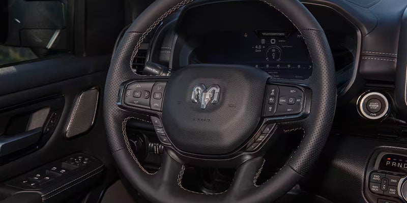 Close-up of RAM 1500 steering wheel and dashboard controls