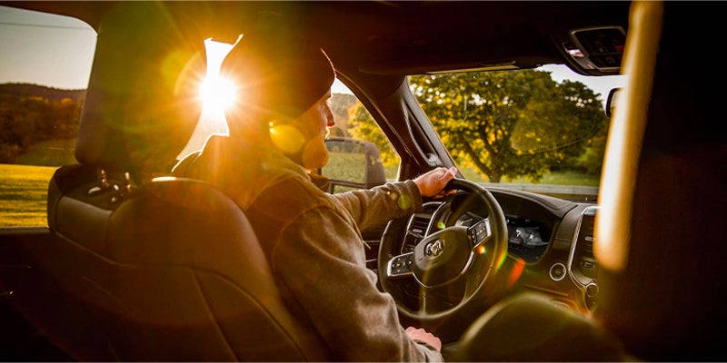 Driver in a Ram Power Wagon with bright sun flare through the window