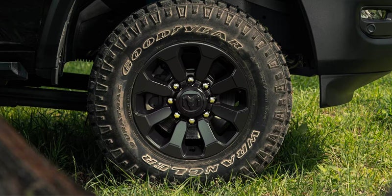 Close-up of a Goodyear Wrangler DuraTrac tire on a black wheel