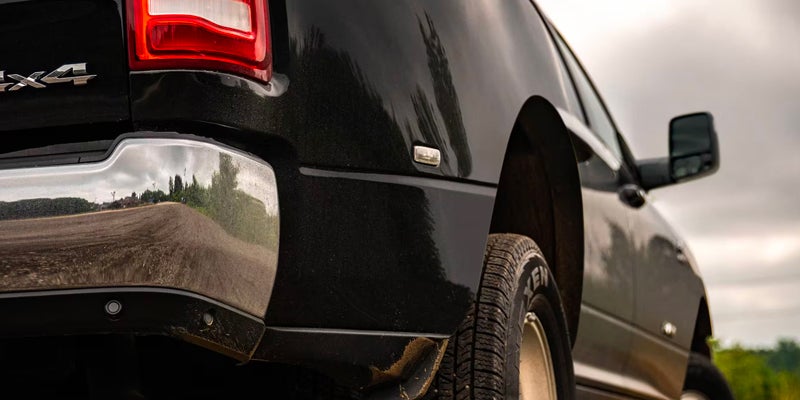 A RAM 3500 truck towing a trailer in rugged terrain