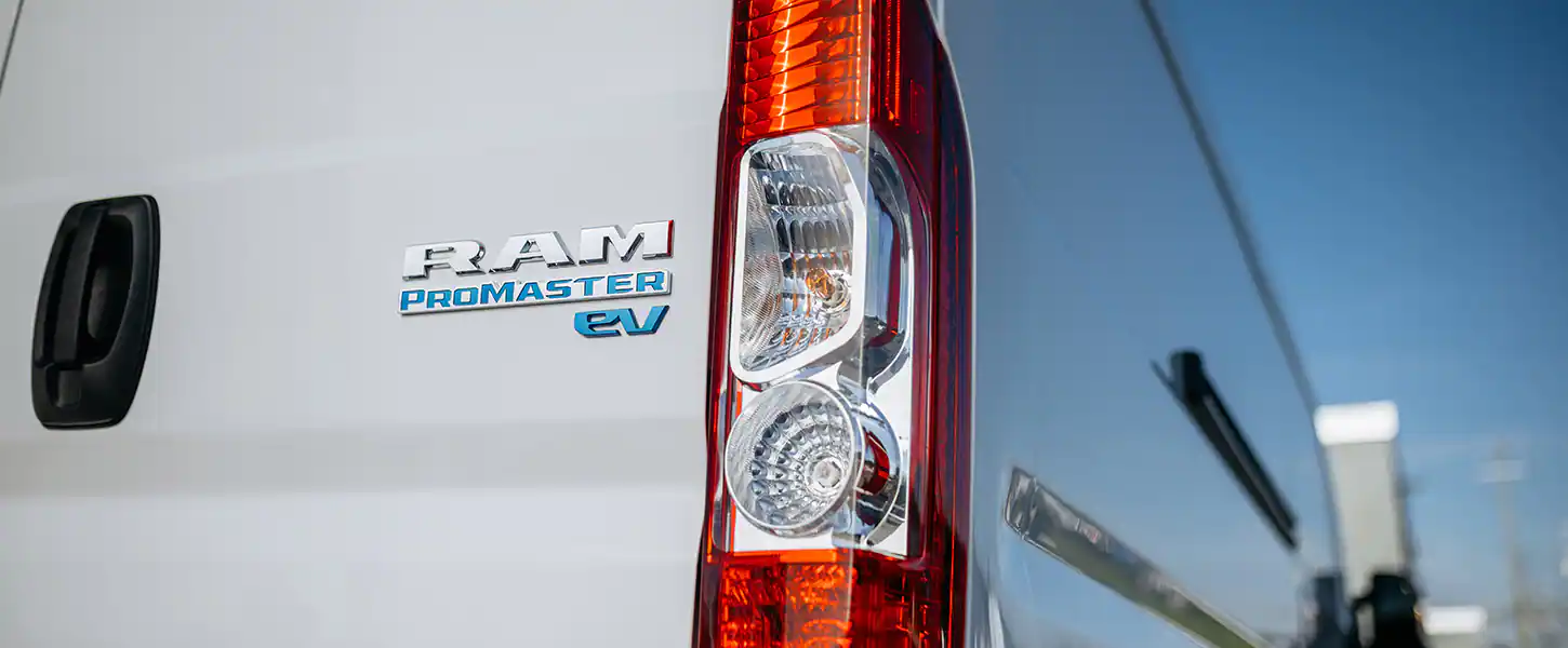 Close-up of the RAM PROMASTER EV badge and taillight on the van